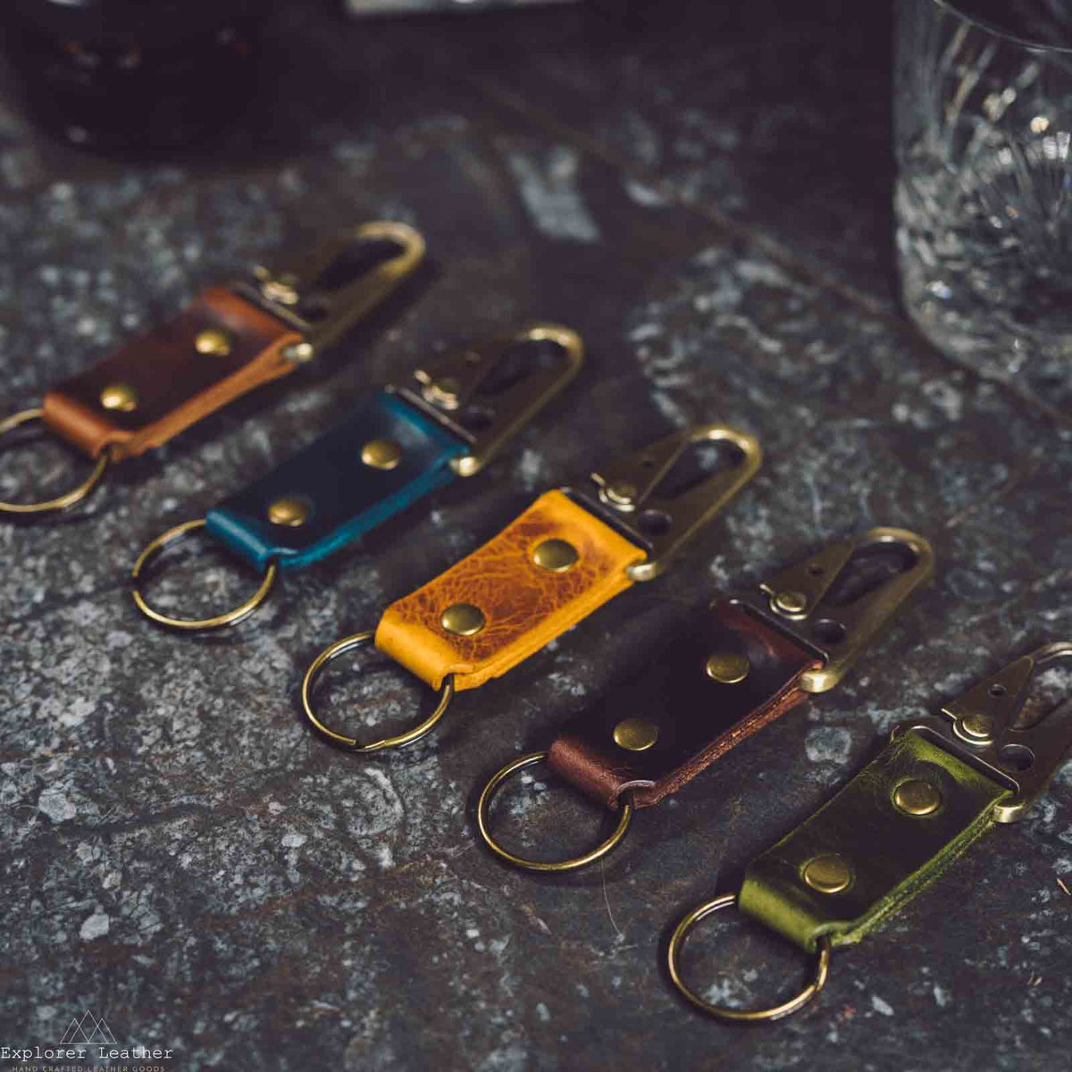 Three leather key rings in assorted colours