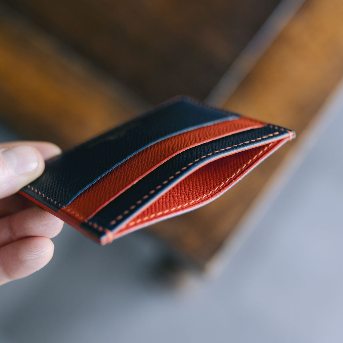 Side profile of five pocket card holder showing layered pockets