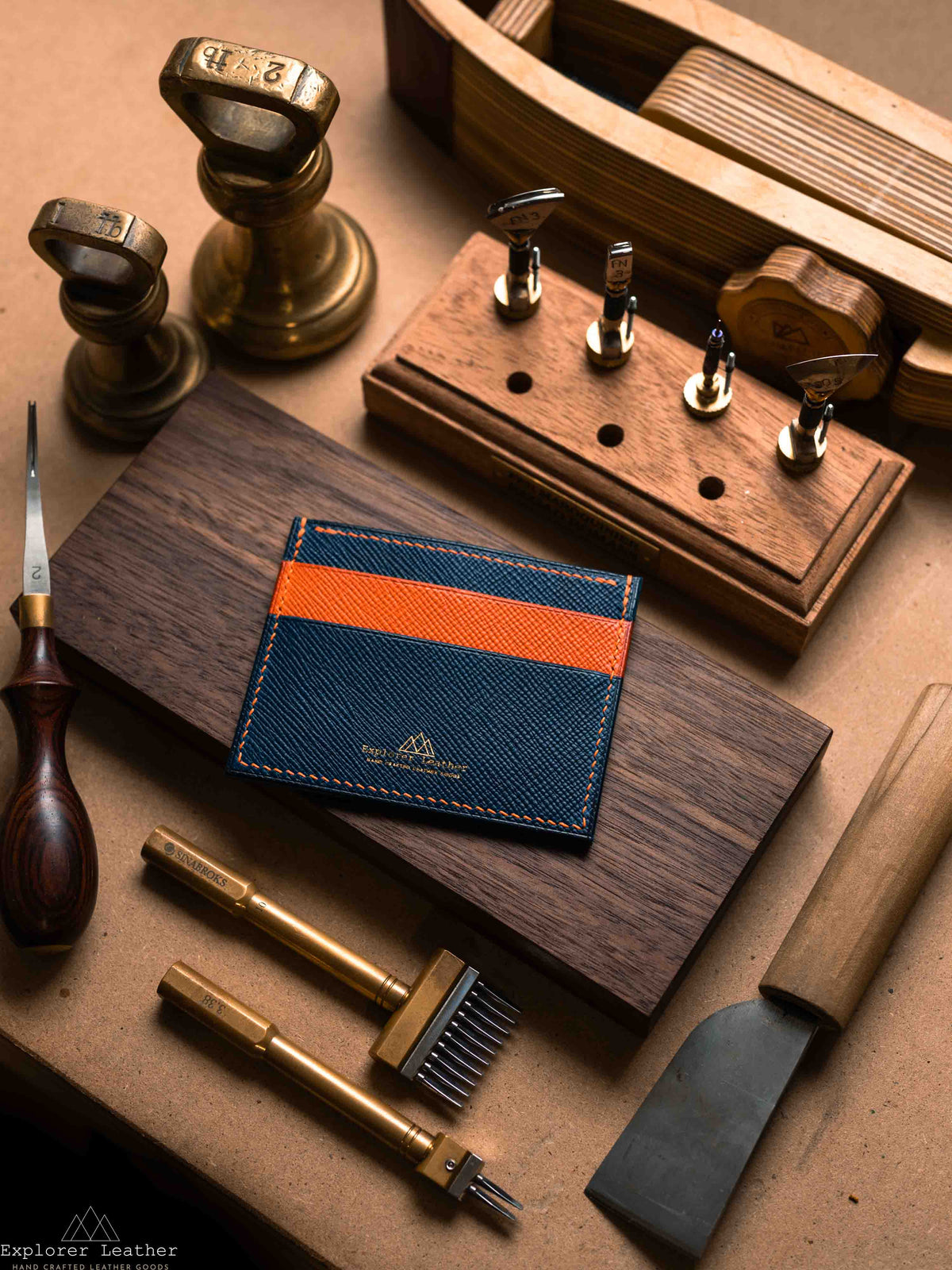 Navy and orange five pocket card holder on a workbench