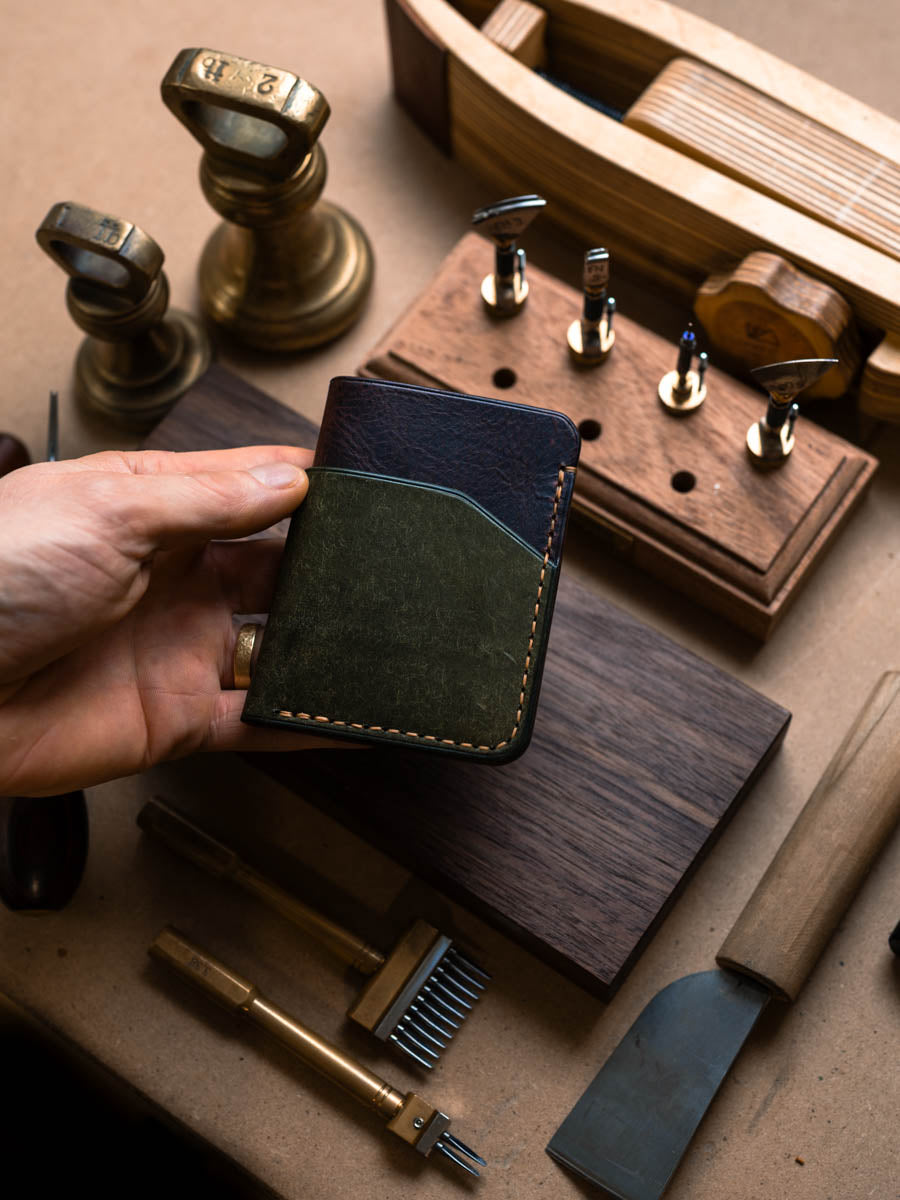 Three pocket card holder held in hand showing olive panel