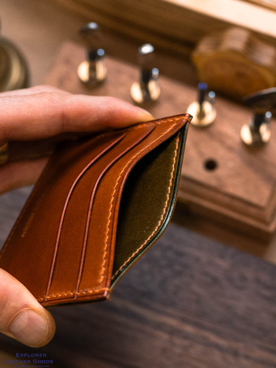 Close-up of the olive green inner and central pocket of the cognac Buttero card holder