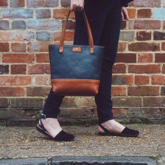 Walking next to brick wall with Tote bag