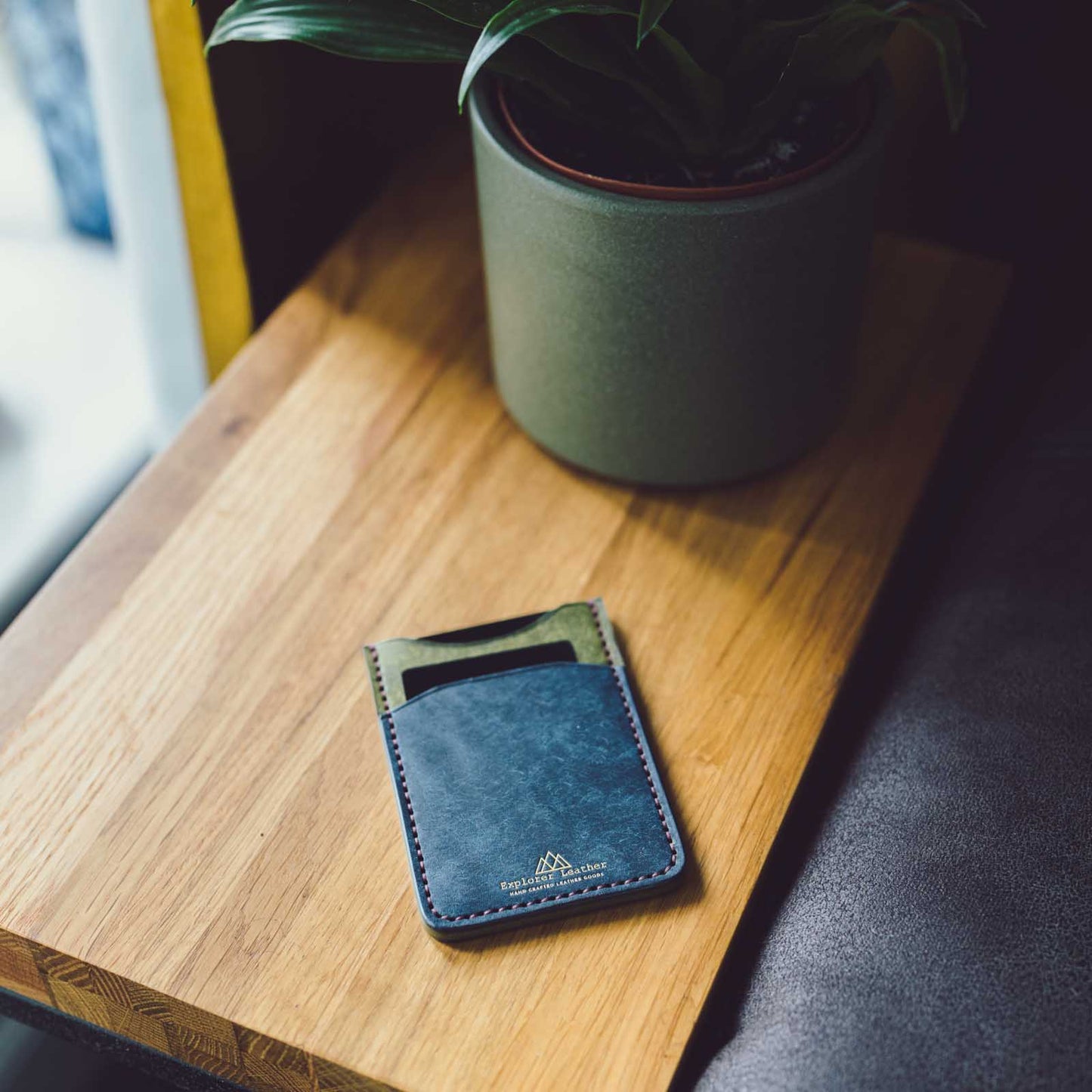 Navy and Oliva 3 pocket card holder on table