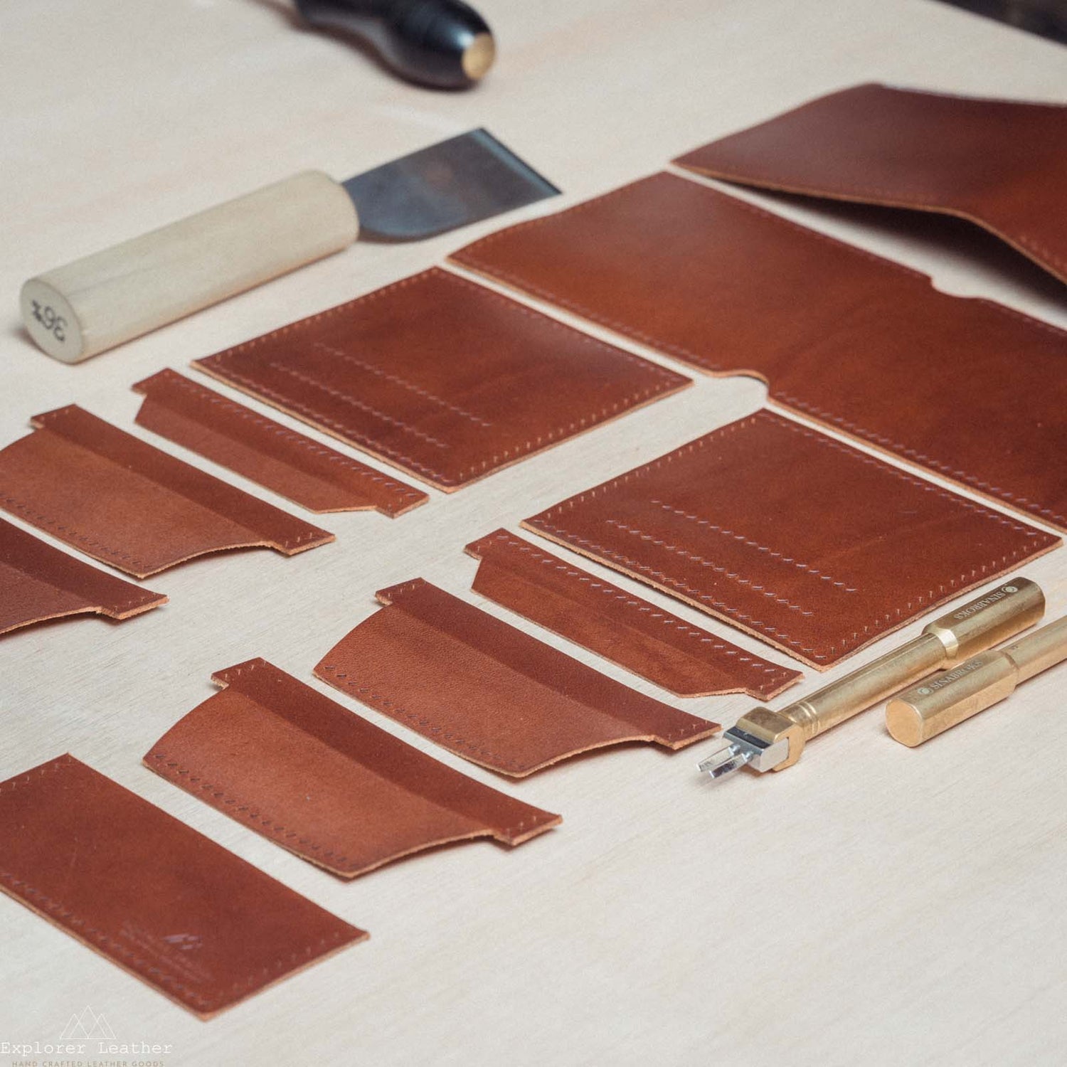 brown tan, leather wallet pieces cut out, leather hand tools.