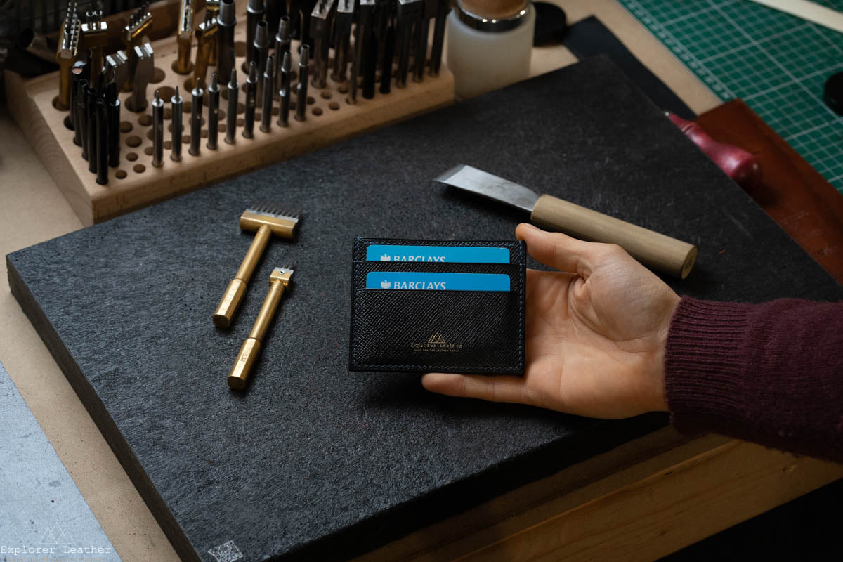 Black, five pocket, card holder, hatch grain, pebble grain. full grain, italian leather, navy blue stitching, with cards in the pocket