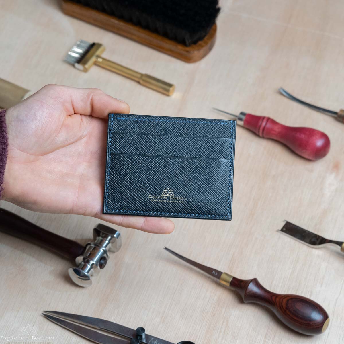 Black, five pocket, card holder, hatch grain, pebble grain. full grain, italian leather, navy blue stitching, in the hand