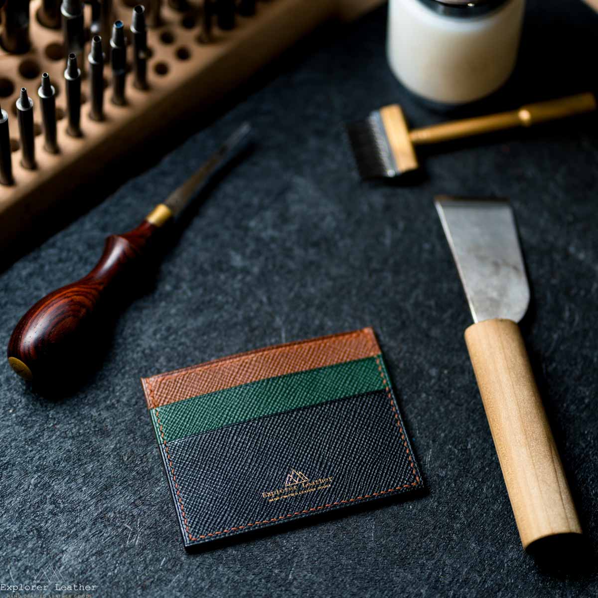 Leather wallet with tools on a dark surface