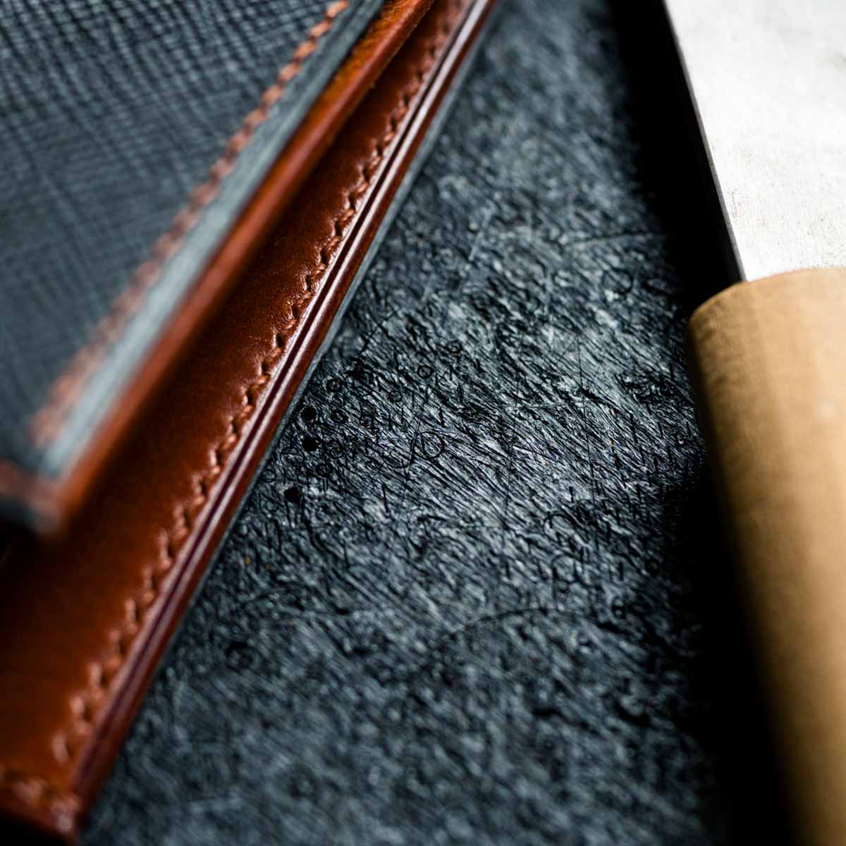 Close-up of a leather wallet on a textured surface