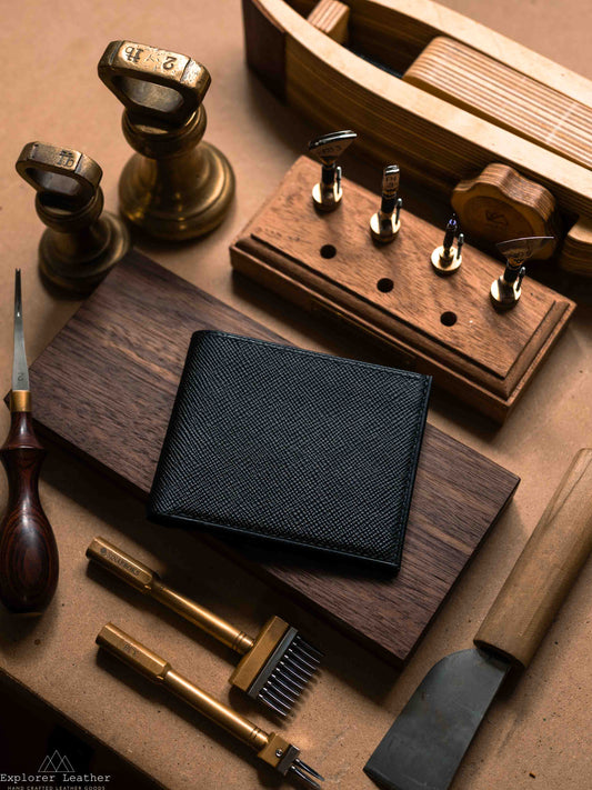 Closed black leather classic bifold wallet on a workbench