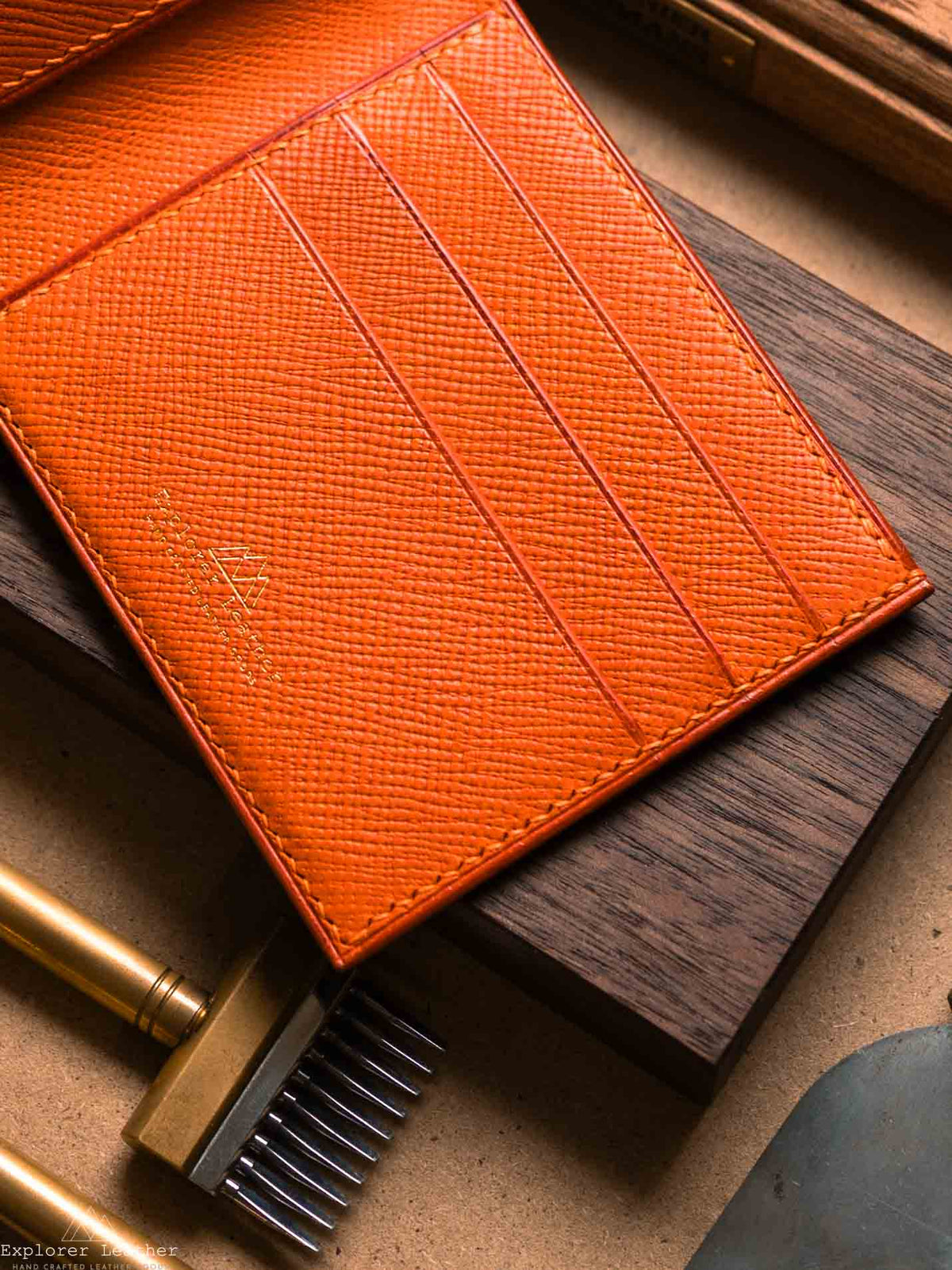 Close view of orange card slots inside navy bifold wallet