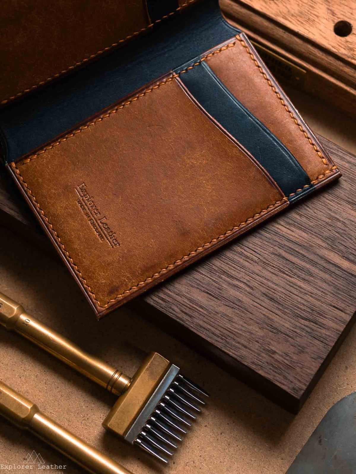Close view of navy and cognac Pueblo card pockets and tan stitching