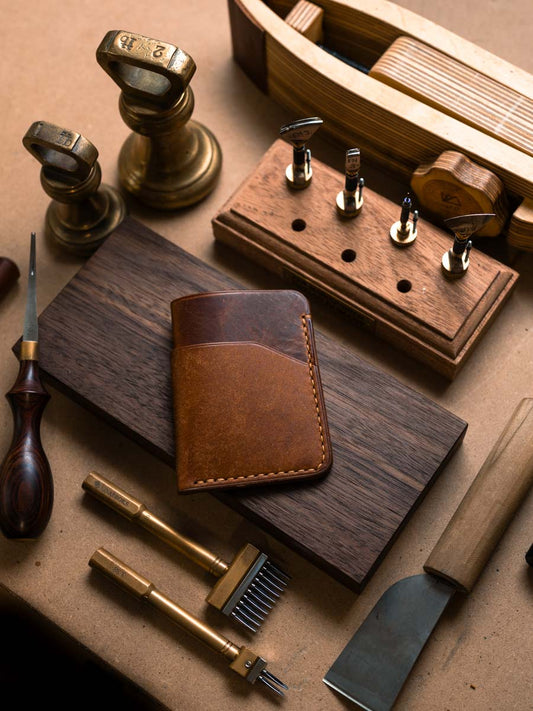 Three pocket Cognac leather card holder on a workbench