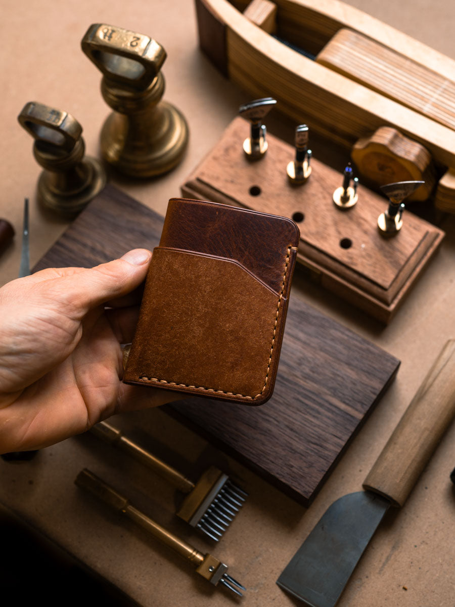 Three pocket Cognac card holder held in hand
