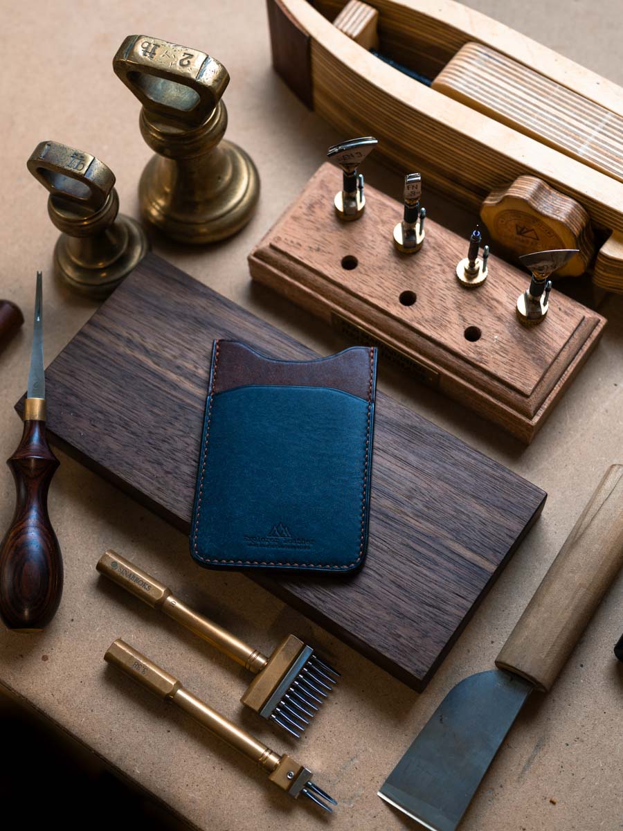 Three pocket leather card holder on a workbench
