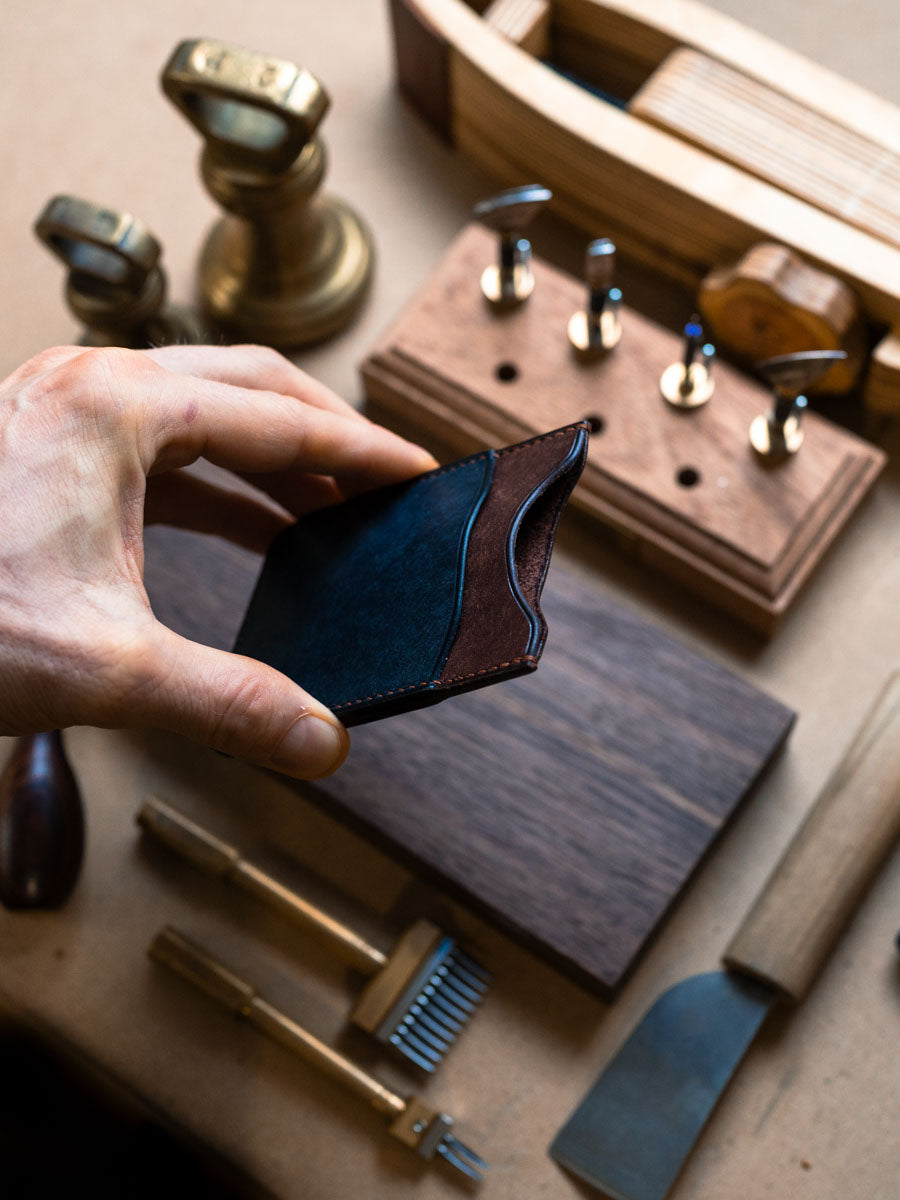 Three pocket card holder held open to show slots