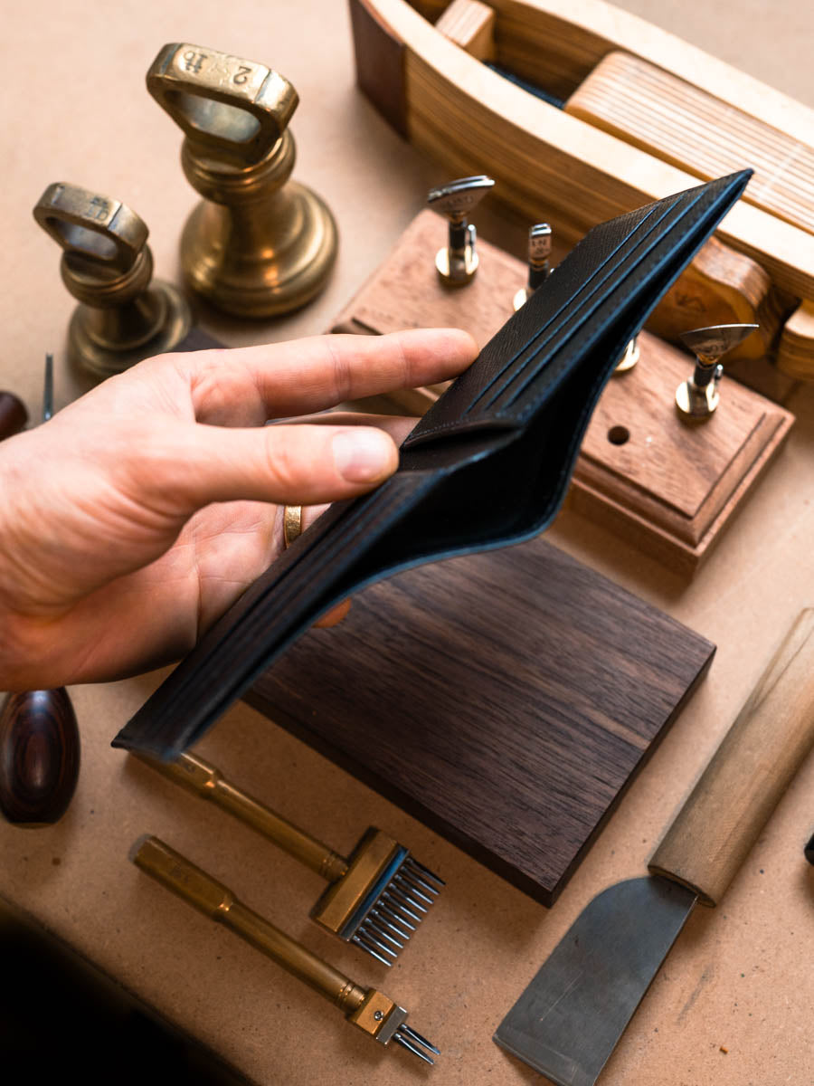 Side profile of black leather bifold wallet